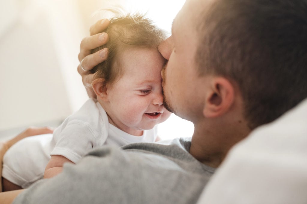 Father kissing baby